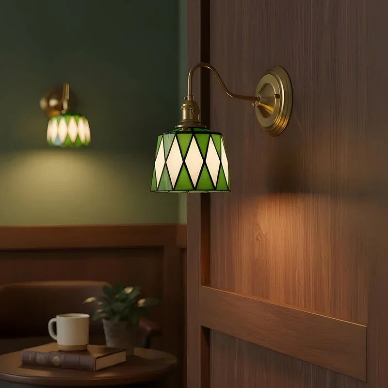 Green patterned wall sconce in a bedroom
