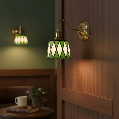 Green patterned wall sconce in a bedroom