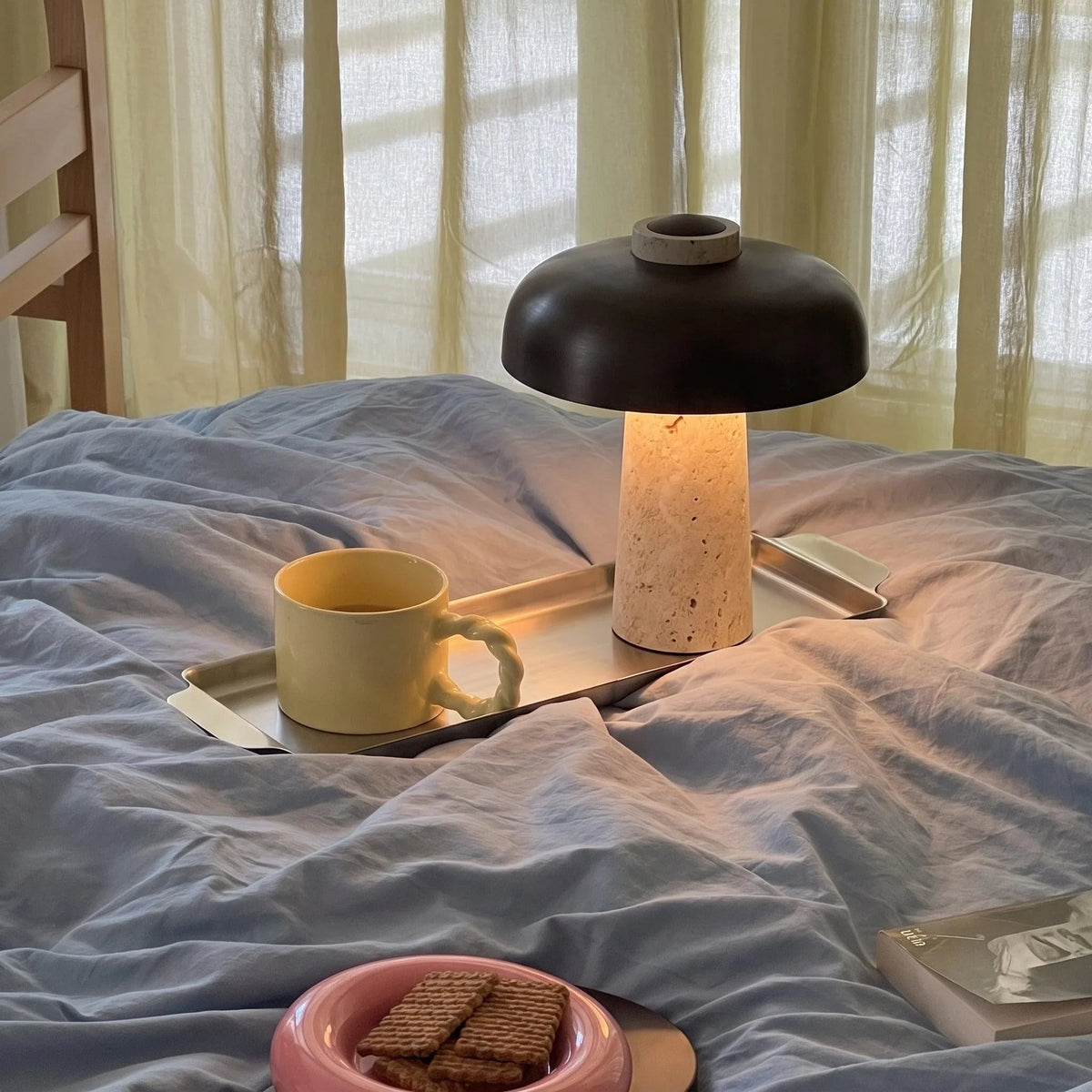 Black dome travertine lamp on a bedside tray