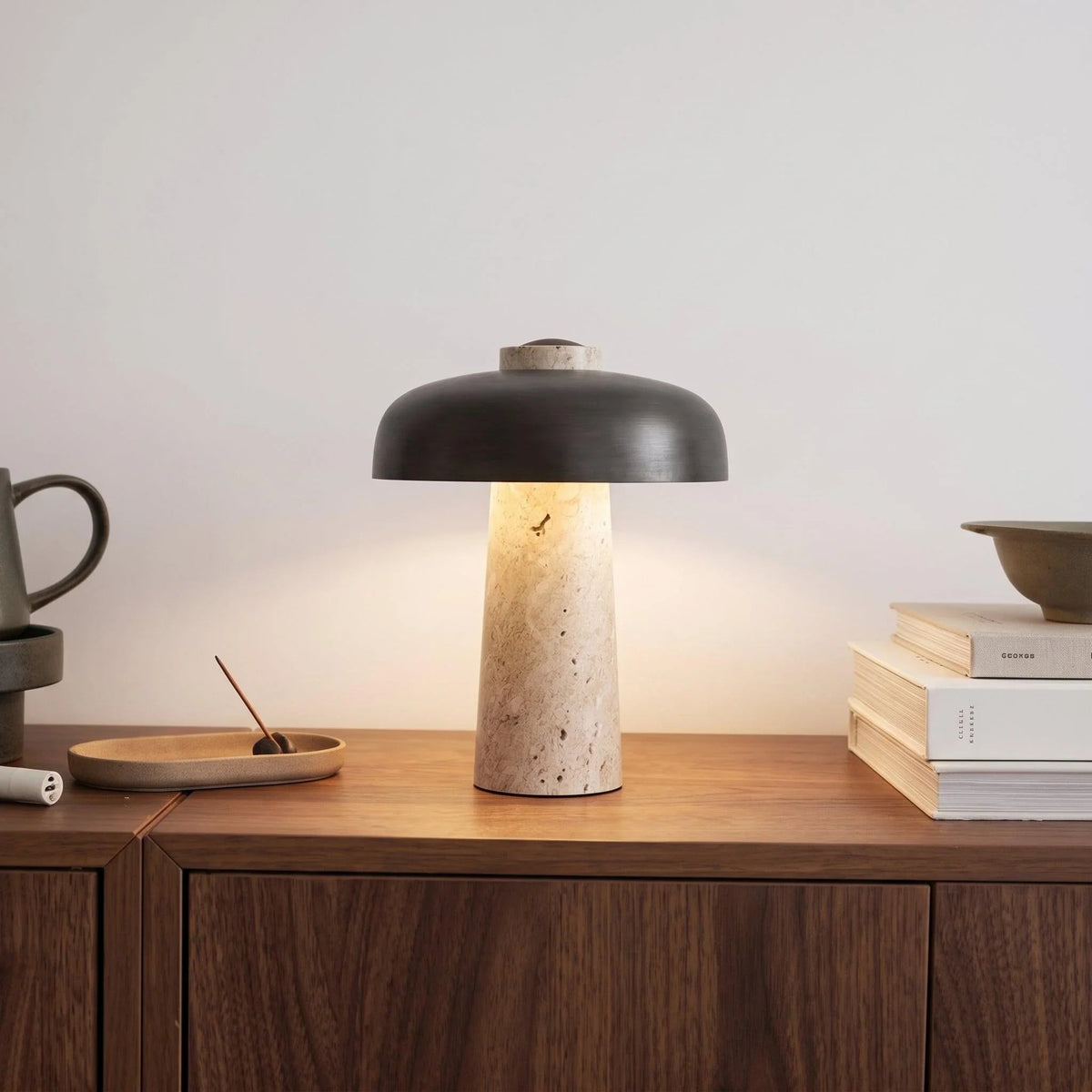 Black shade travertine table lamp on a cabinet