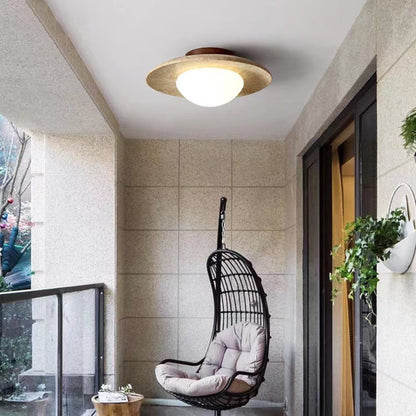 Travertine ceiling light in an enclosed balcony setting