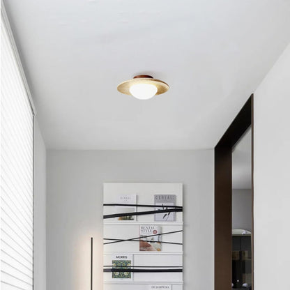 Travertine saucer ceiling light in a hallway