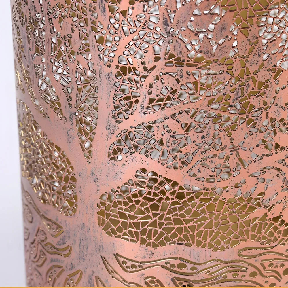 Close-up of the intricate Tree of Life cutout pattern on a copper-coloured metal solar lantern, showing the detailed filigree design.