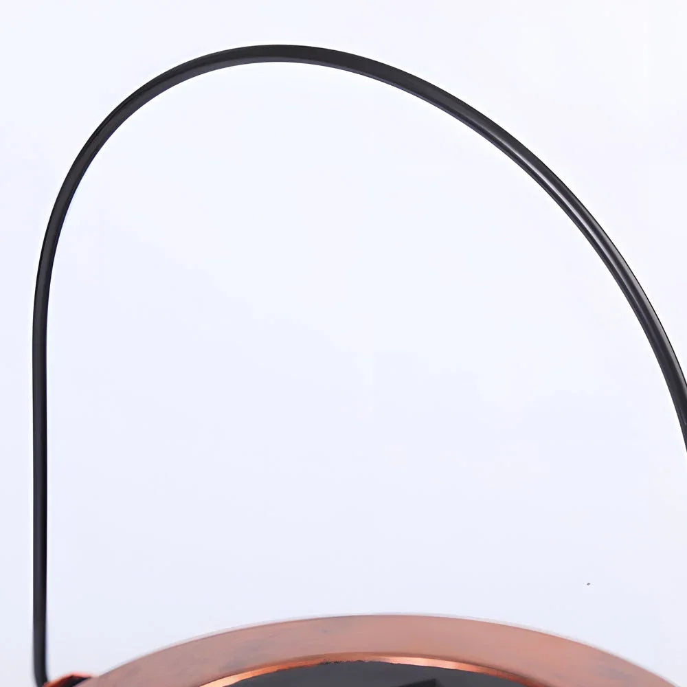 Close-up of the black metal hanging handle attached to the copper-coloured top of the Tree of Life solar lantern for outdoor garden lighting.