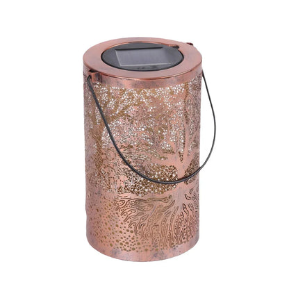 Cylindrical copper-coloured solar lantern featuring an intricate Tree of Life cut-out design, a solar panel on top, and a black wire hanging handle.