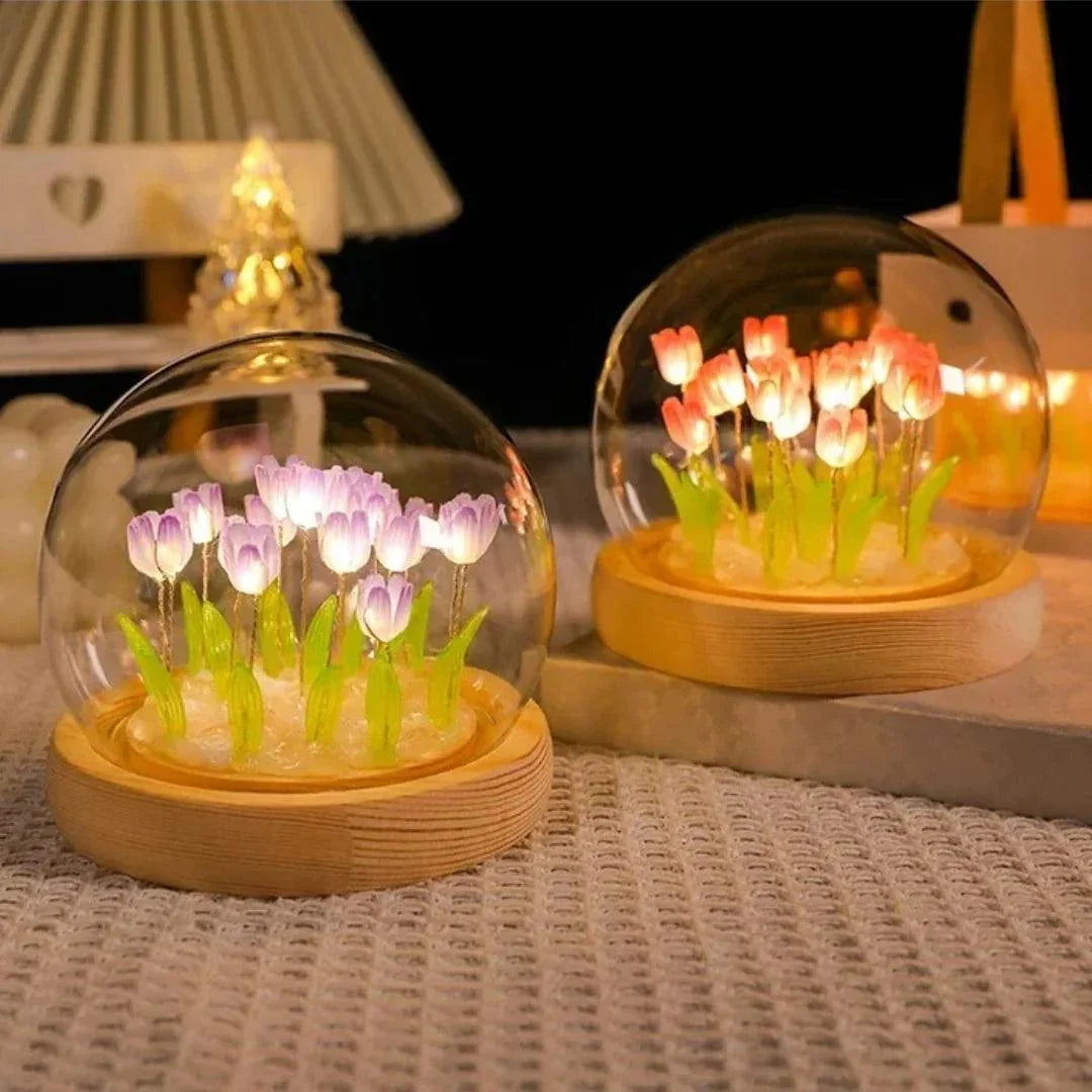 Purple and pink tulip night lights beneath glass domes