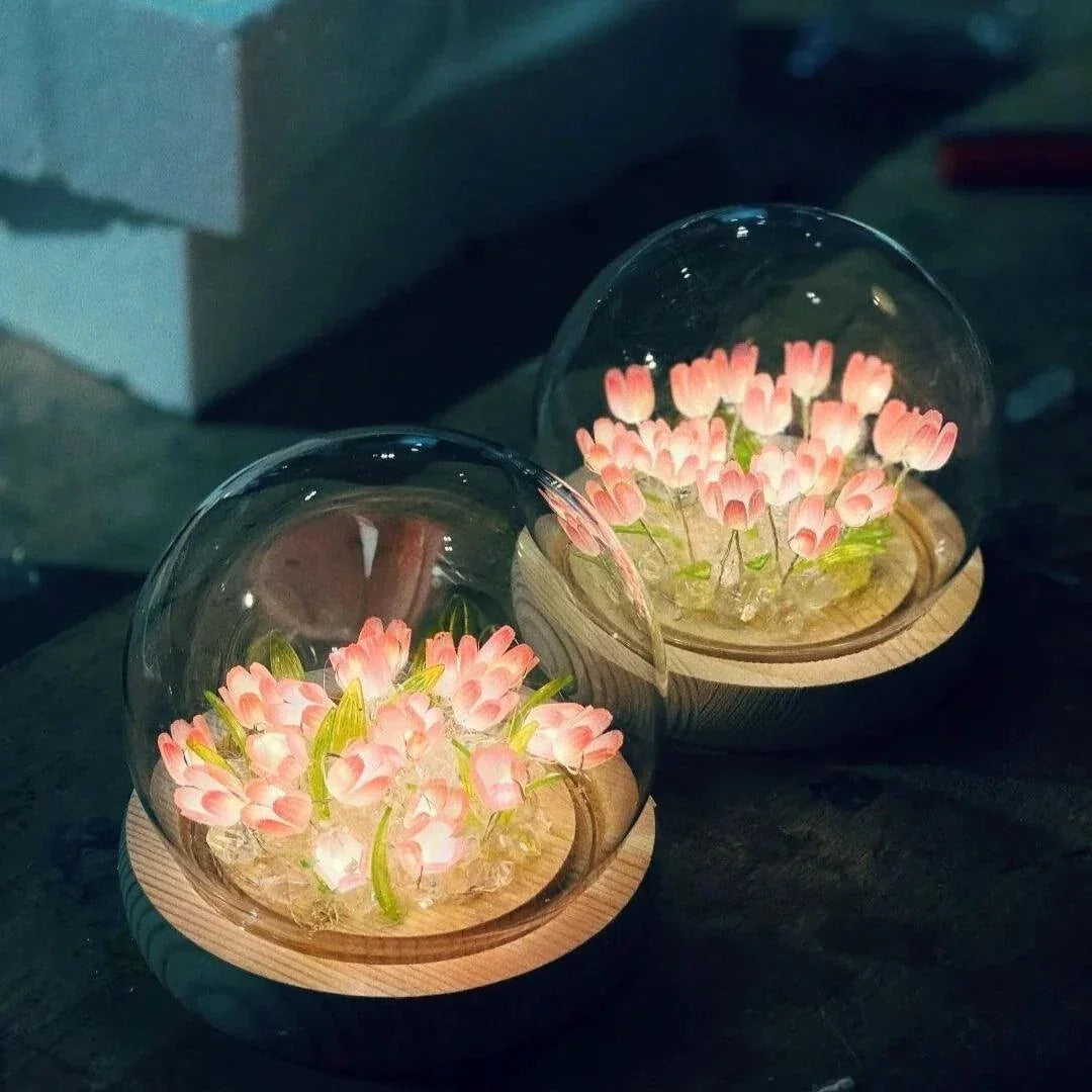 Pink tulip glass dome lights glowing in a dark setting