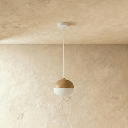 White glass globe diffuser beneath a textured wood-tone shade