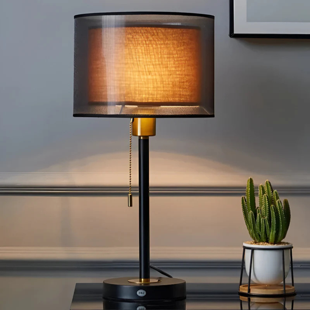 Black vintage table lamp with a double dark fabric shade and warm ambient glow
