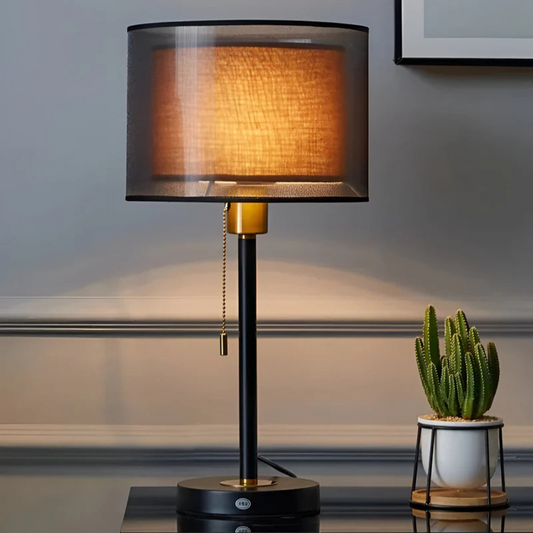 Black vintage table lamp with a double dark fabric shade and warm ambient glow
