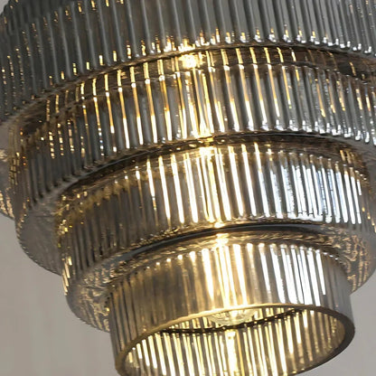 Close view of ribbed glass tiers and bulb