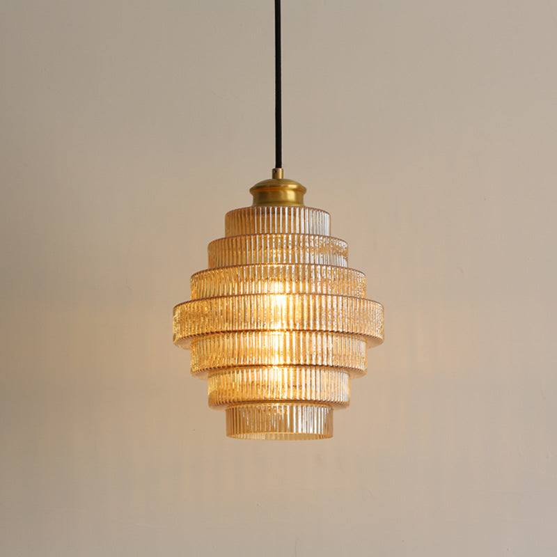 Amber ribbed tiered pendant with warm light