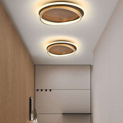 Two walnut-finish ceiling lights illuminating a hallway