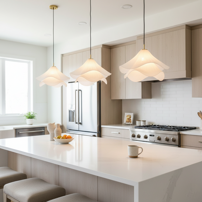 Three wavy fabric pendants above a kitchen island