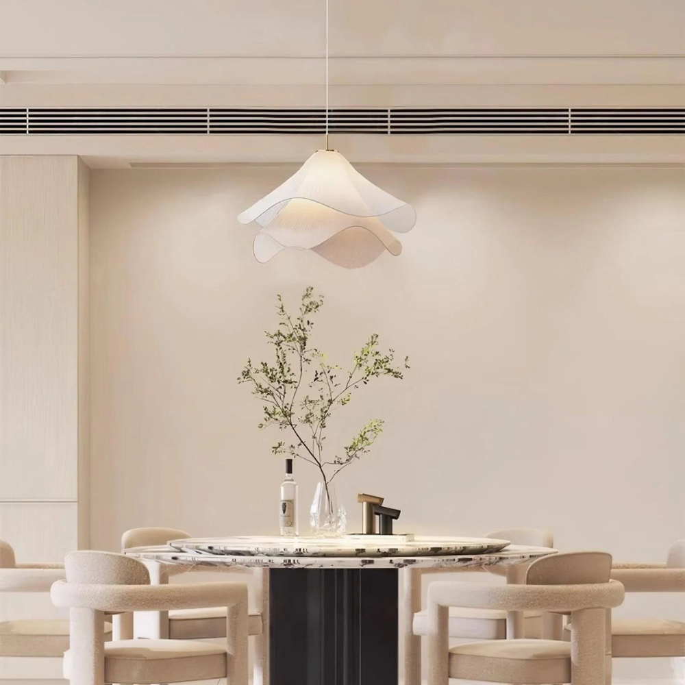 White wavy fabric pendant above a dining table