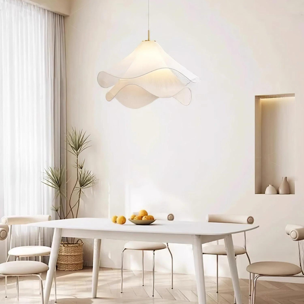 Layered fabric pendant above a white dining table