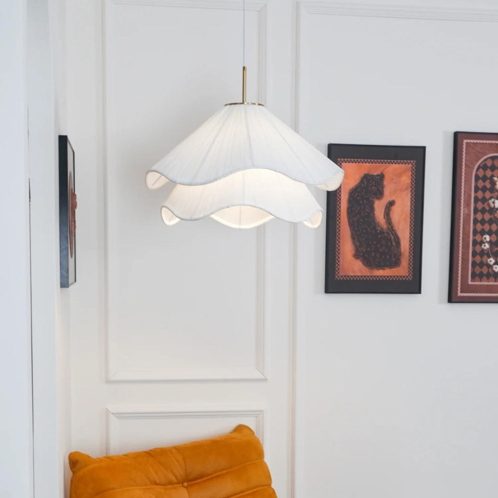 White layered pendant in a room with framed artwork