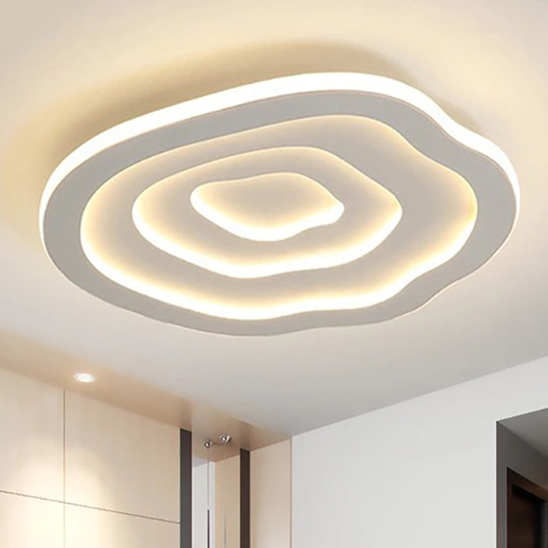 White acrylic wavy ceiling light glowing above a room
