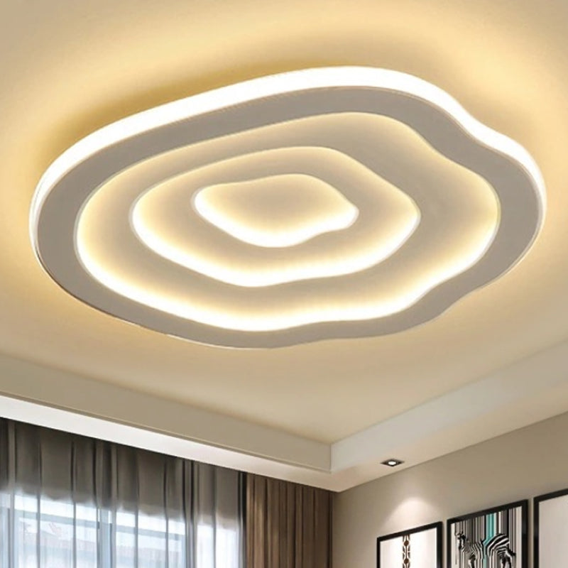 Warmly lit white wavy ceiling light in a modern interior