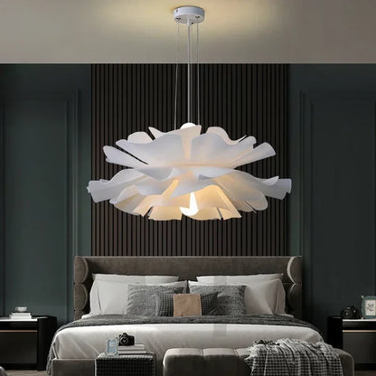 White lotus flower pendant light above a bed