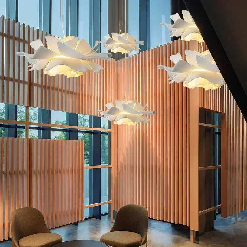 White flower pendant lights hanging at different heights
