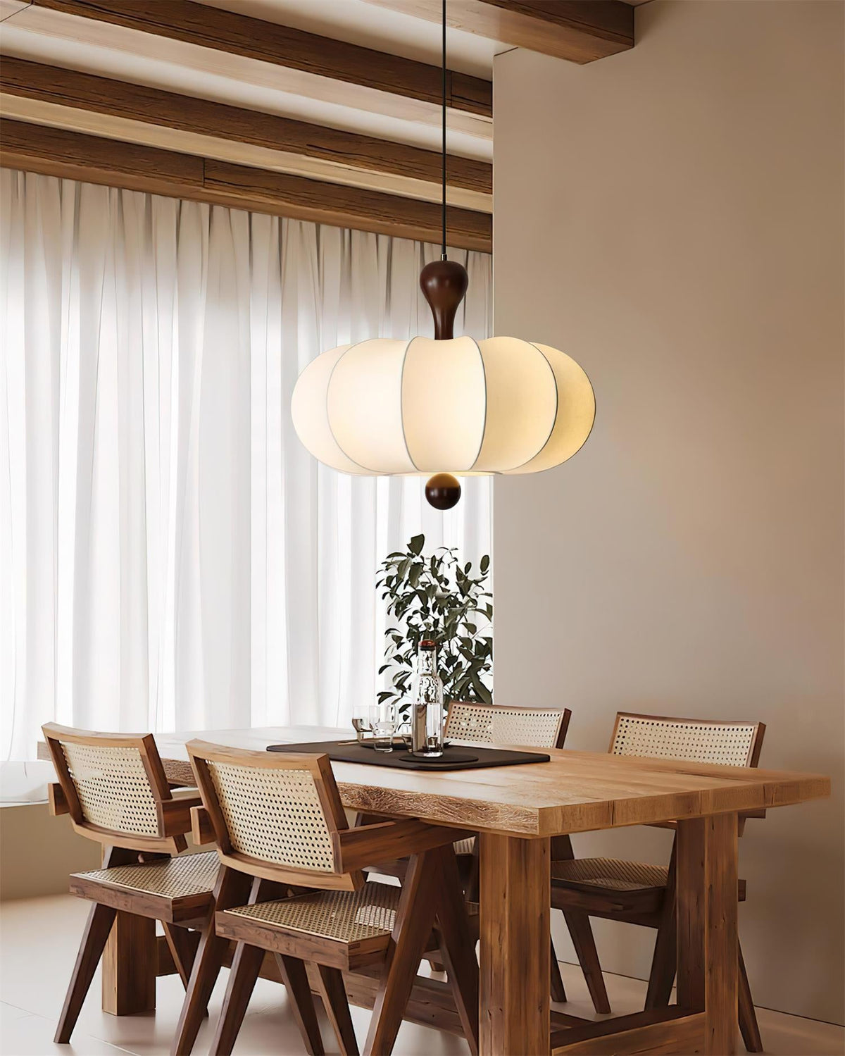 White sculptural pendant above a dining table