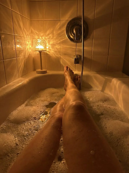 Aurora borealis lamp creating warm light beside a bath