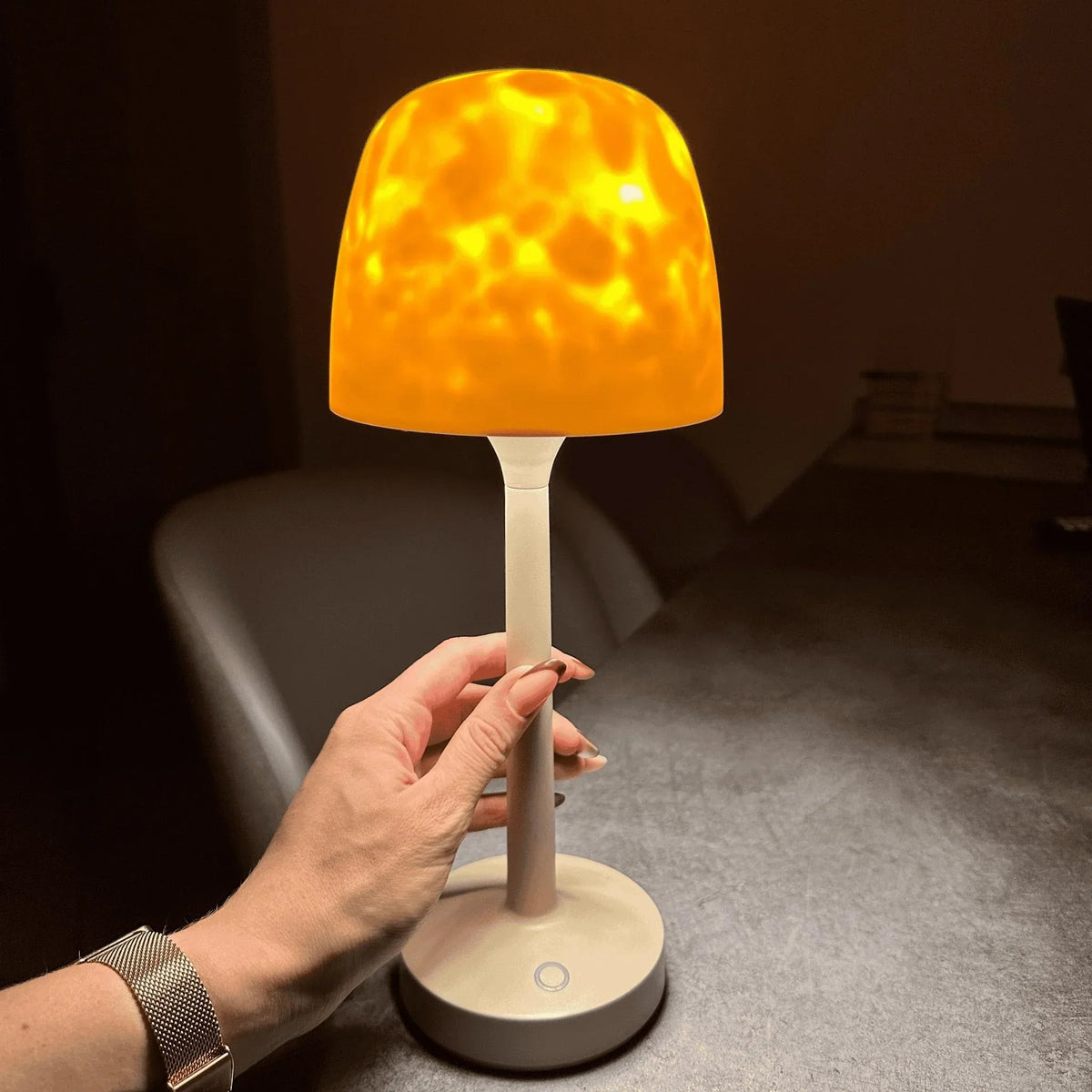 Hand holding a wireless aurora borealis table lamp