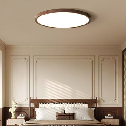 Wood-effect flush ceiling light above a bed