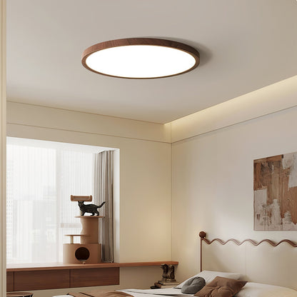 Wood-effect round ceiling light in a bedroom