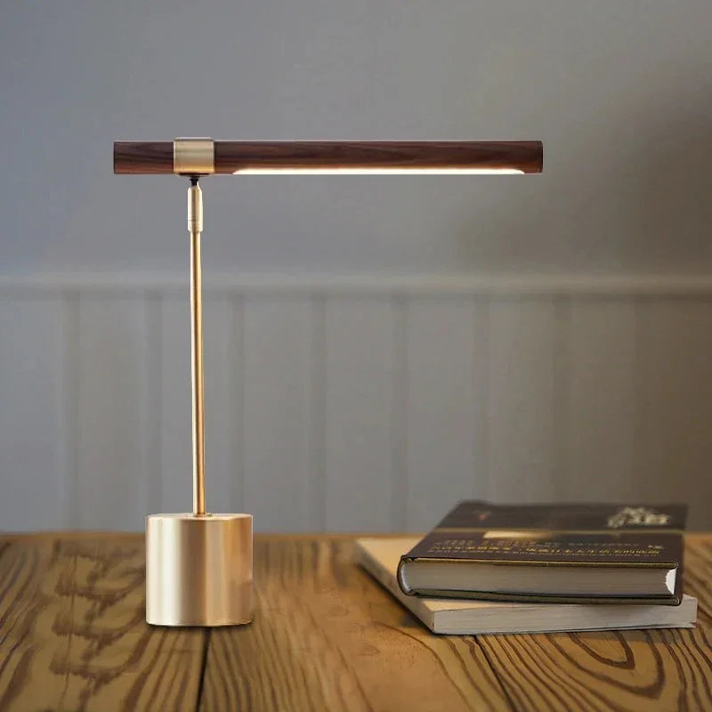 Wood light-bar table lamp beside books on a sideboard