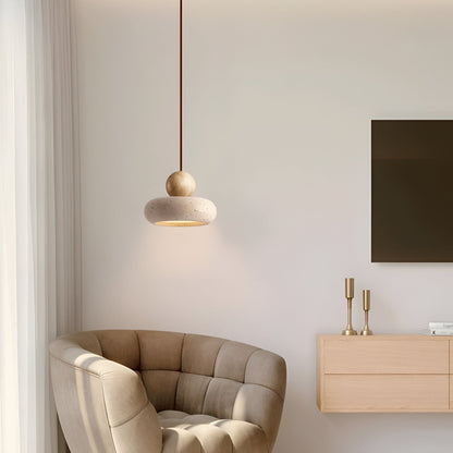 Light wood and travertine pendant beside an armchair
