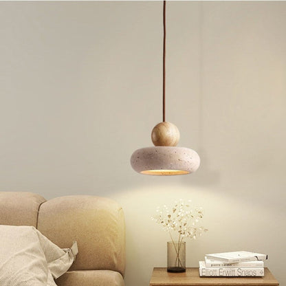 Light wood and travertine pendant beside a sofa