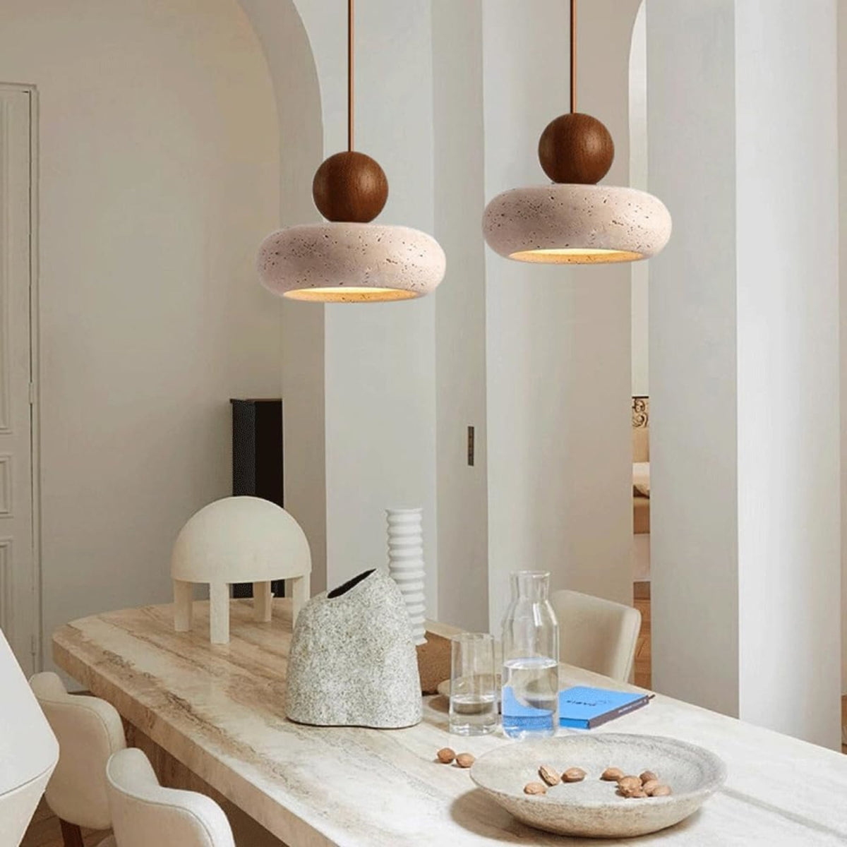 Walnut and travertine pendant lights above a dining table